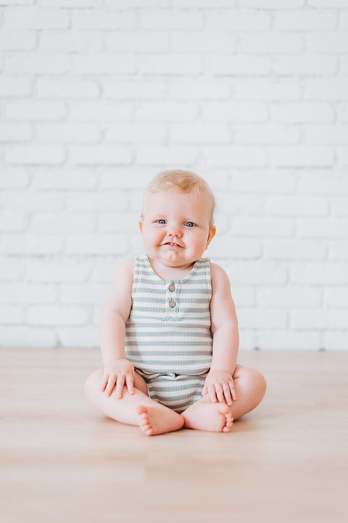 Fort Worth Baby Photography - baby smiling while sitting on floor