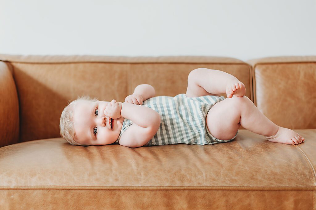 Fort Worth Baby Photography - baby laying on his back on a couch 