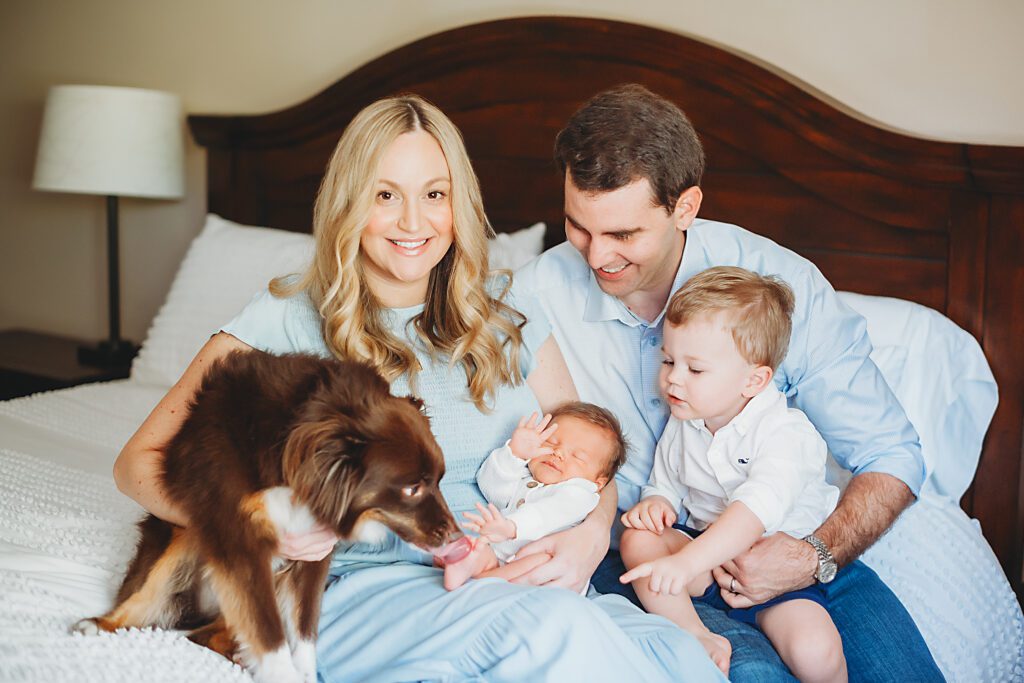 Family with newborn baby boy and dog