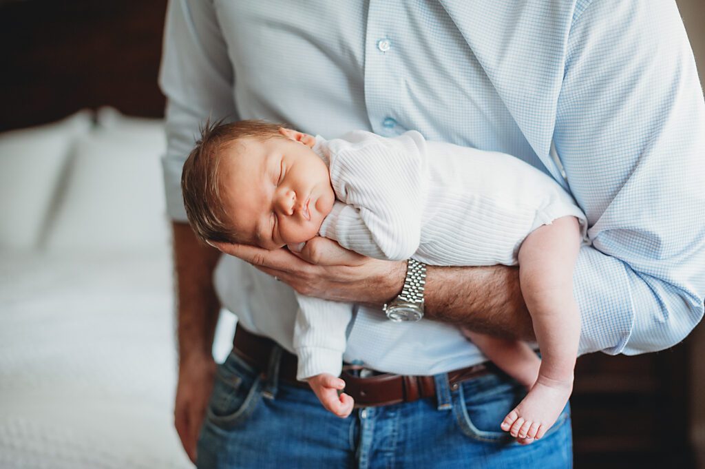 Dallas Newborn baby boy in his dads arms.