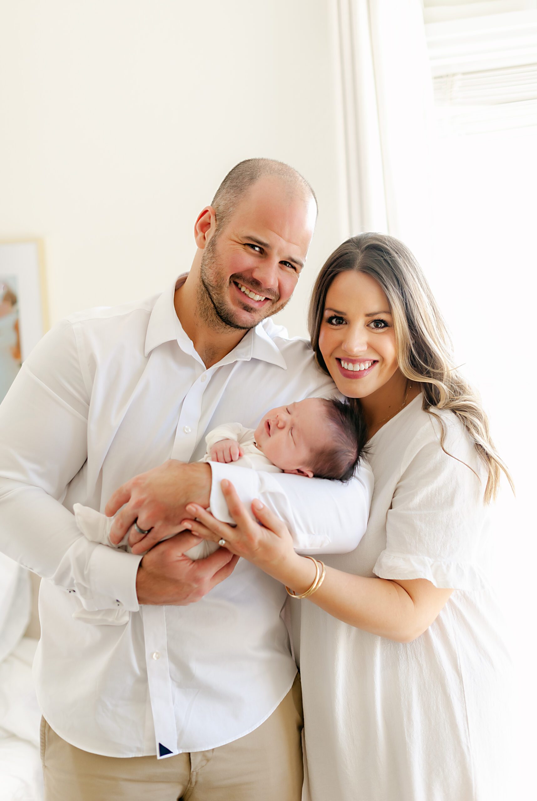 Mom and dad holding newborn baby boy in a Fort Worth newborn photographer session with Splendor Photography
