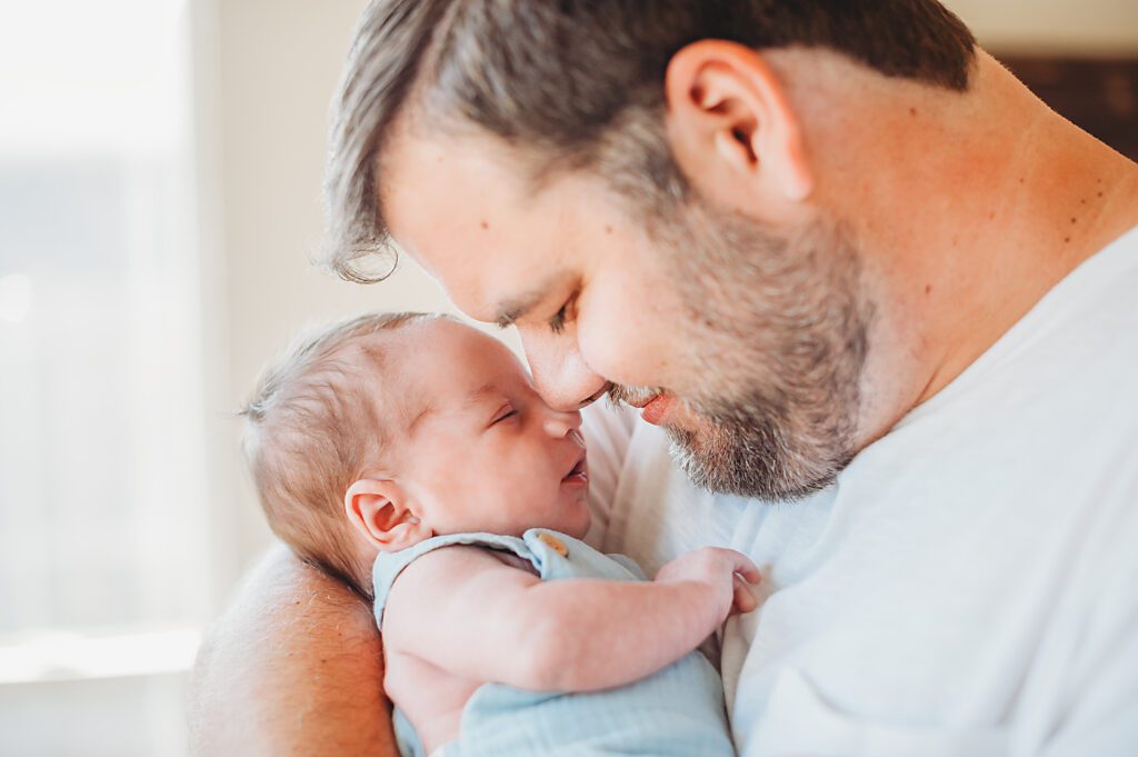 Dad snuggling bay DFW newborn session